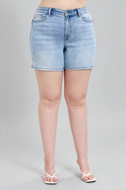 Light blue denim shorts worn by a person on a gray background
