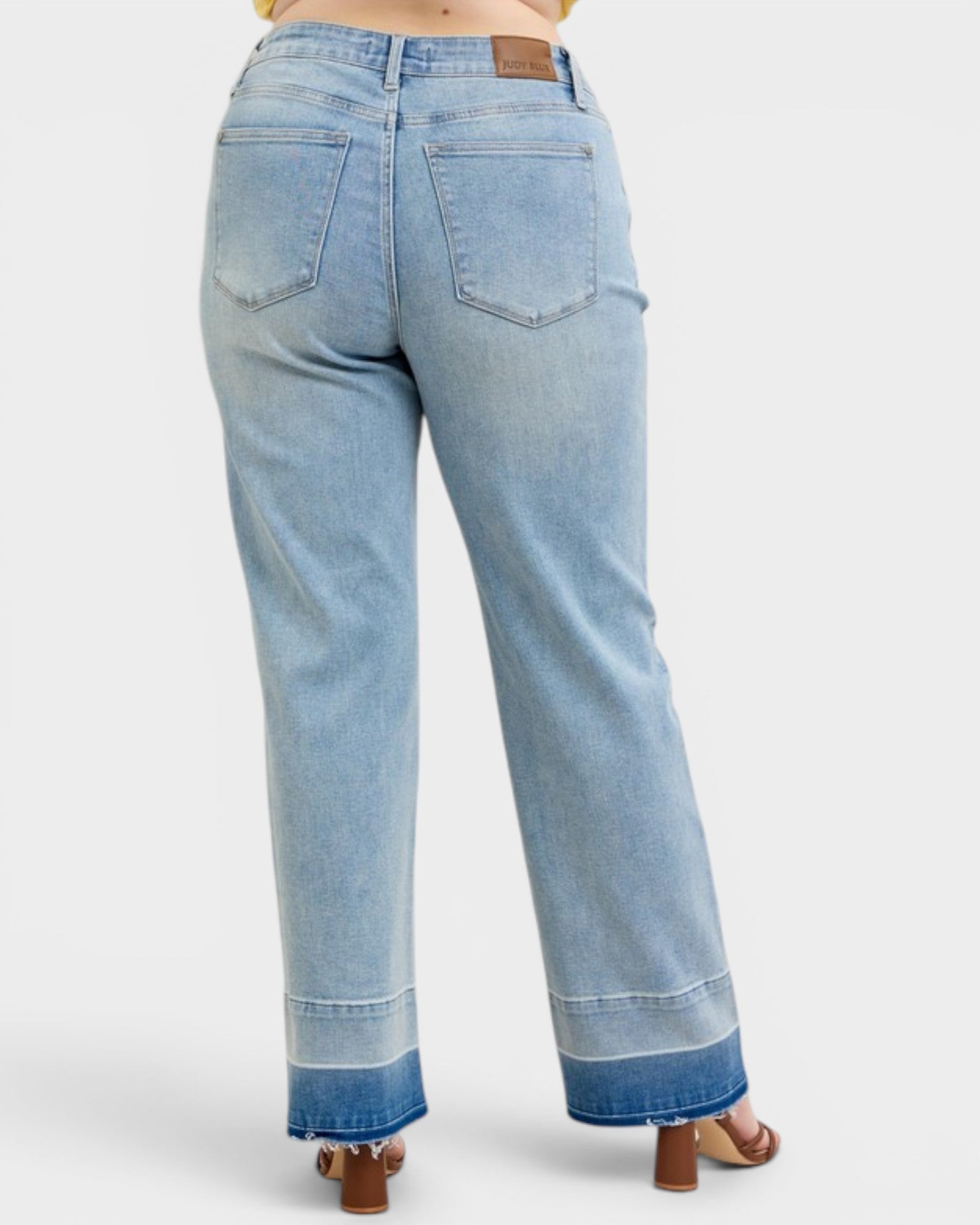 Light blue jeans worn by a person on a white background