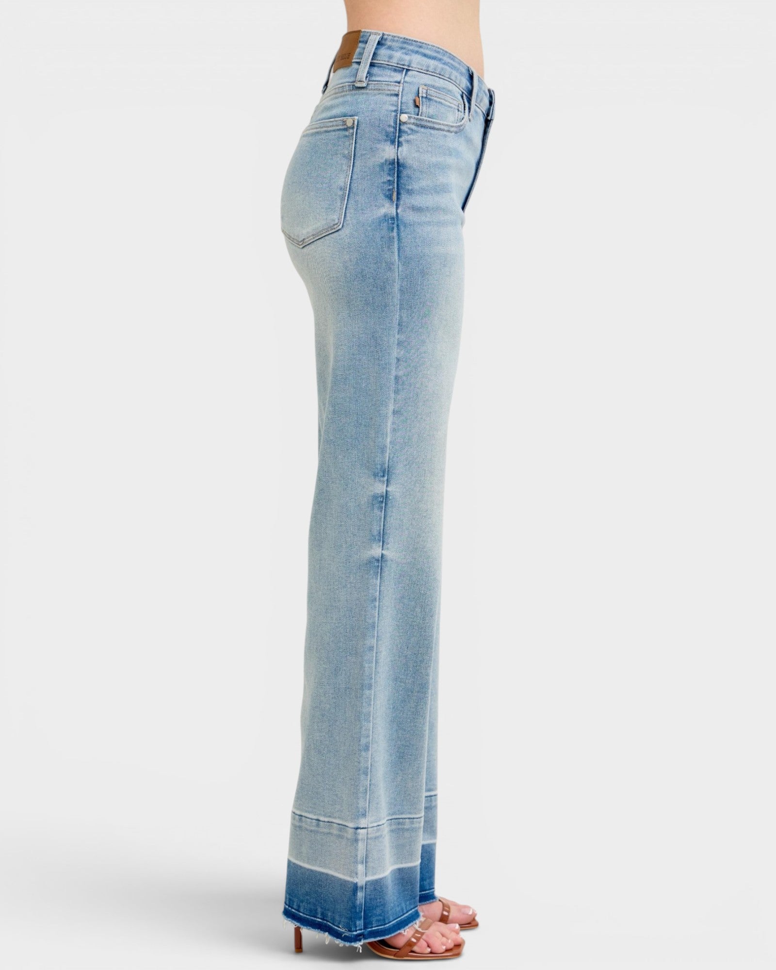 Light blue denim jeans on a white background