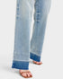 Close-up of light blue jeans with a white background