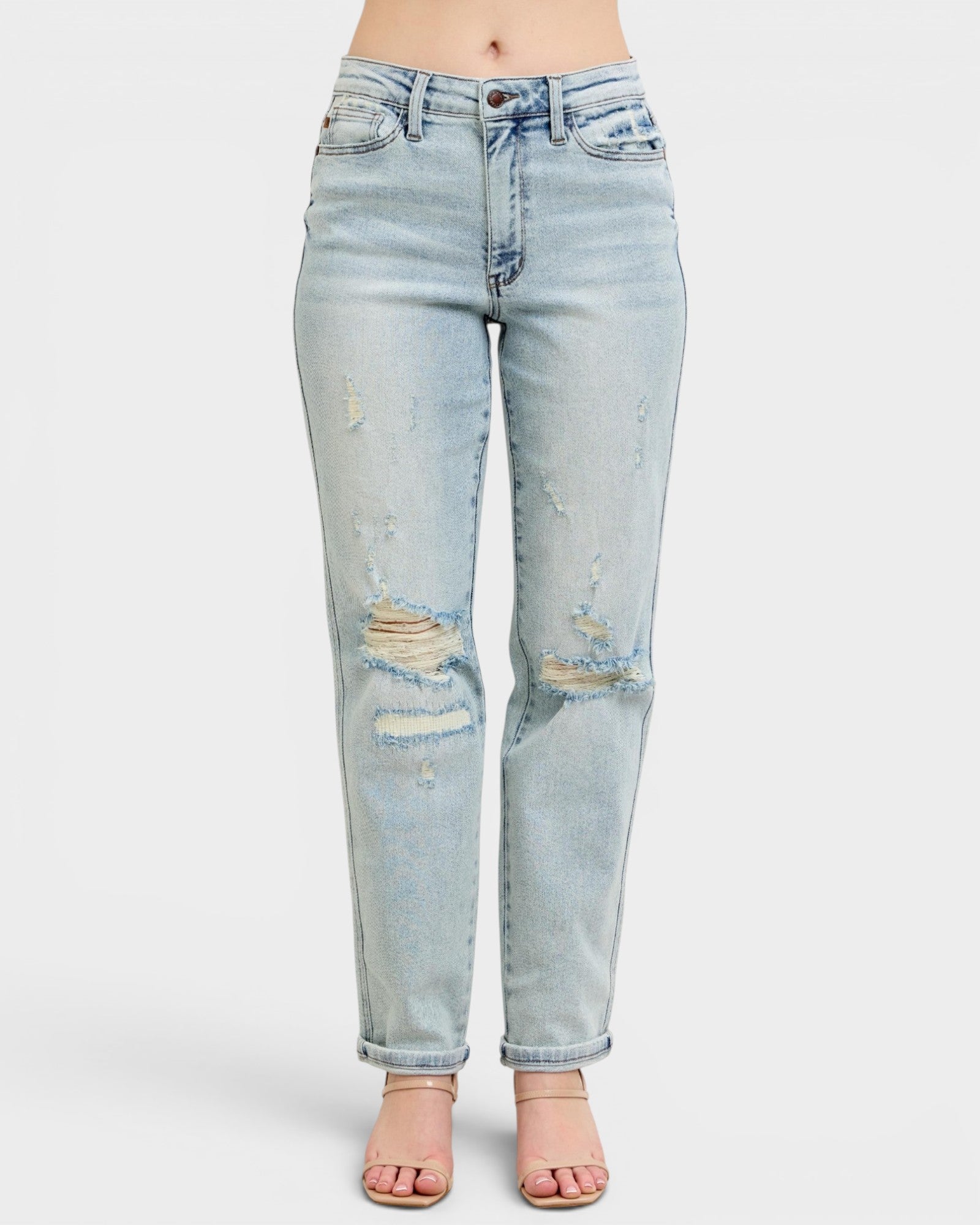 Light blue distressed jeans on a white background