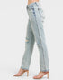 Light blue distressed jeans worn by a person on a white background