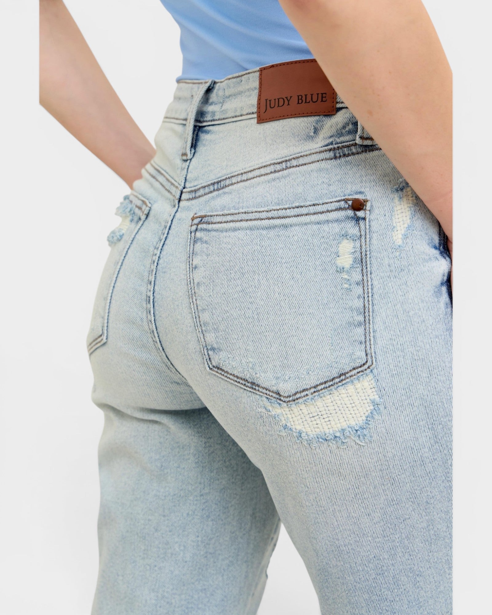 Light blue jeans with a brand label on a white background
