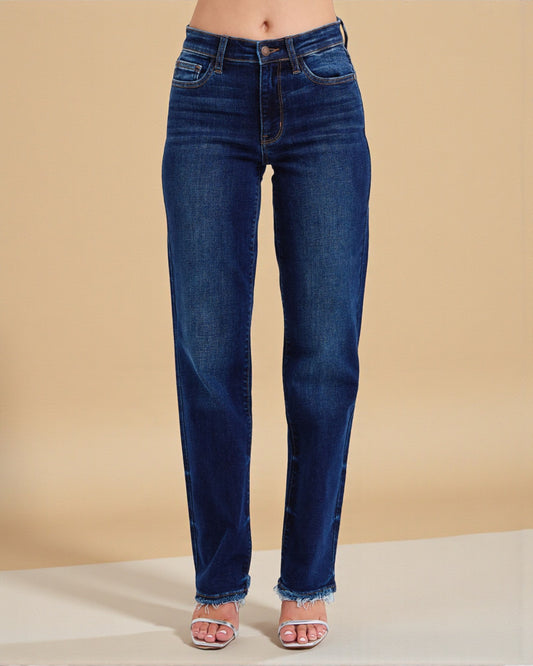 Blue jeans worn by a person on a beige background