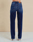 Blue jeans worn by a person on a beige background