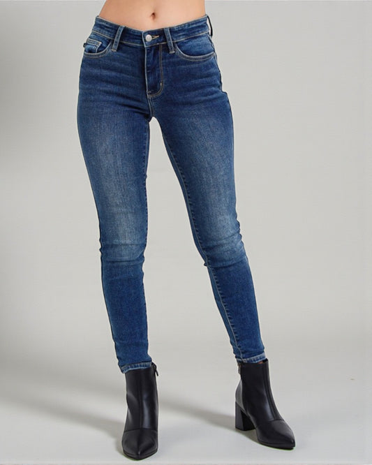 Blue jeans worn by a person on a gray background
