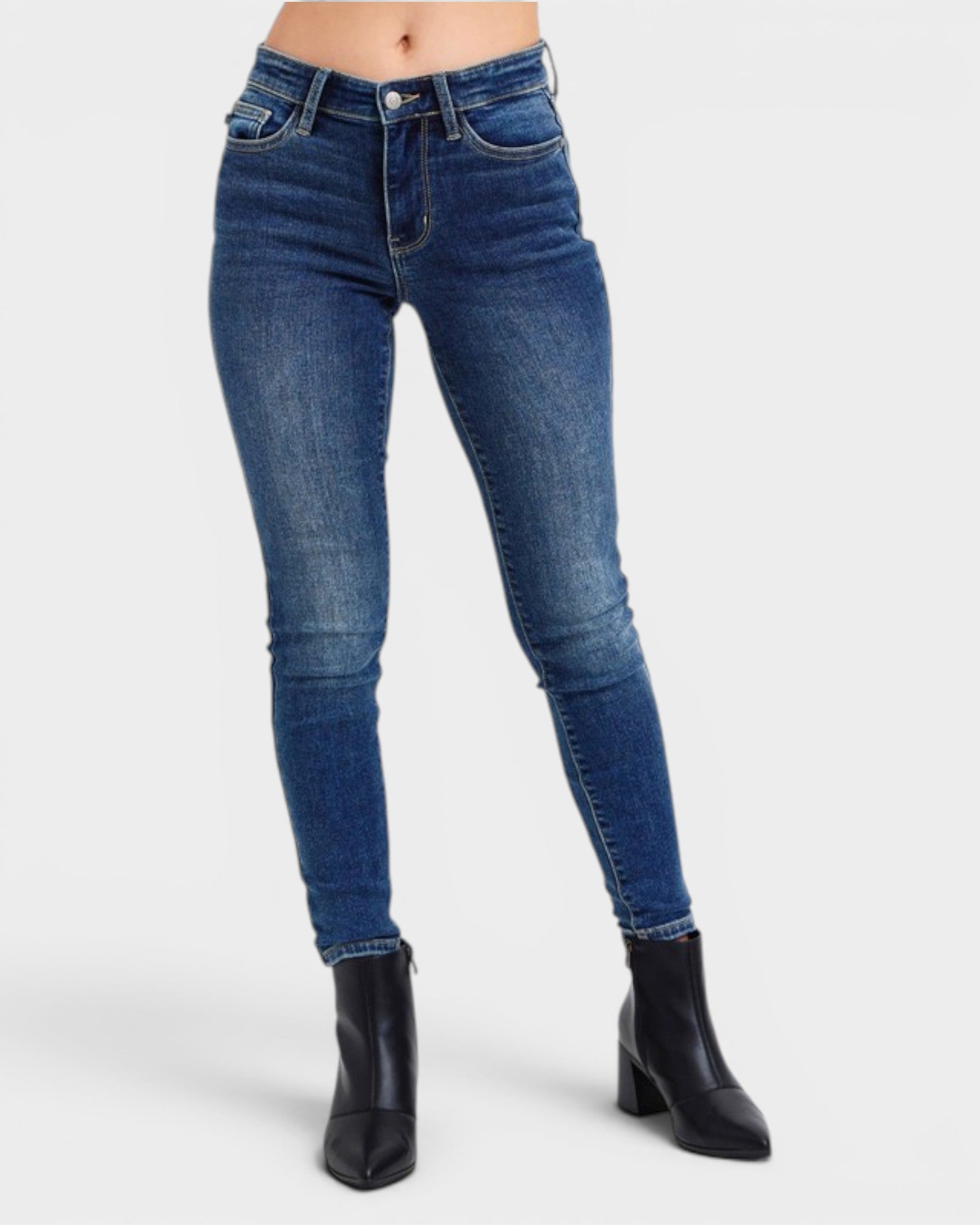 Blue jeans worn by a person on a white background