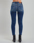 Blue jeans worn by a person on a gray background
