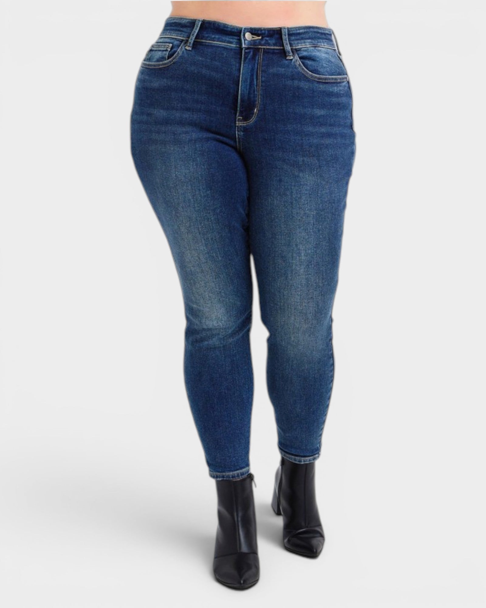Blue jeans worn by a person on a white background