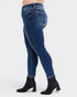 Blue jeans worn by a person on a white background