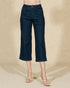 Dark blue jeans worn by a person on a beige background