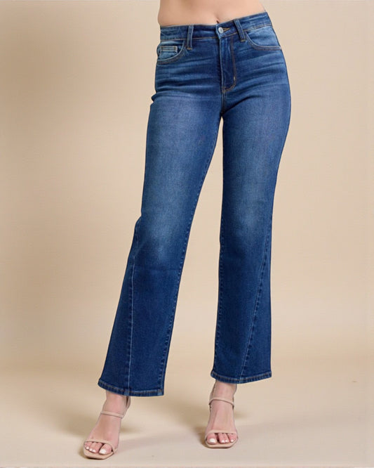 Blue jeans worn by a person on a beige background