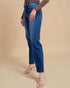 Person wearing blue jeans on a beige background