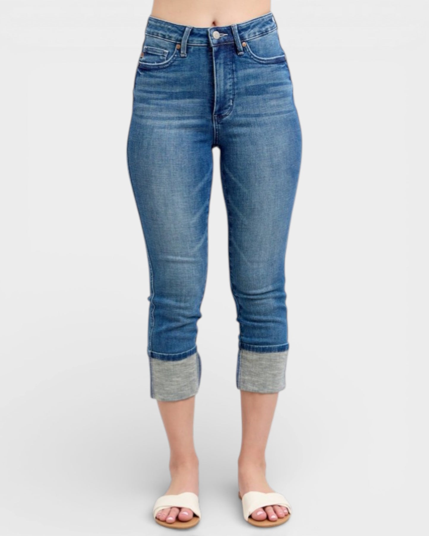 Blue jeans with rolled-up cuffs on a white background