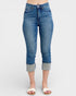 Blue jeans with rolled-up cuffs on a white background