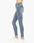 Light blue high-waisted skinny jeans shown on a model from the waist down, paired with white sneakers against a plain white background.
