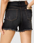 Black denim shorts worn by a person on a plain background