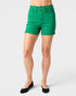 Green shorts worn by a person on a white background