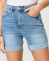 Light blue denim shorts worn by a person on a plain background