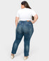 Woman wearing blue jeans and a white top on a white background