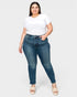 Woman wearing blue jeans and a white t-shirt on a white background