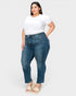 Woman wearing blue jeans and a white t-shirt on a white background