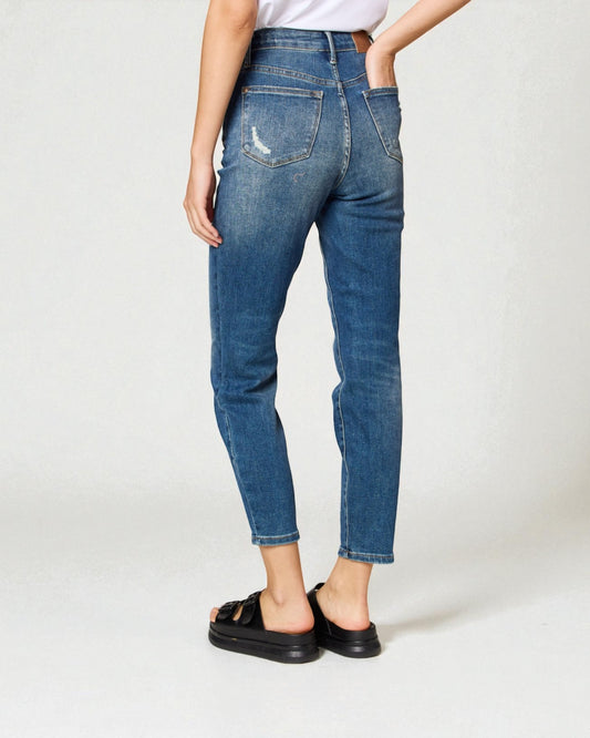 Person wearing blue jeans on a white background