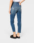 Person wearing blue jeans on a white background