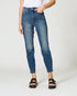 Person wearing blue jeans and black sandals on a white background