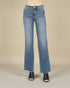 Blue jeans worn by a person on a beige background