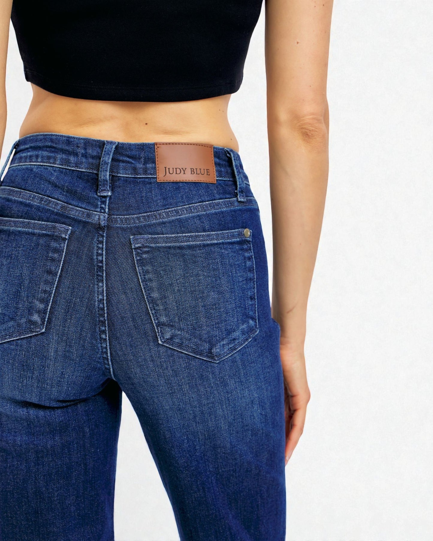 Blue jeans with Judy Blue label on a white background