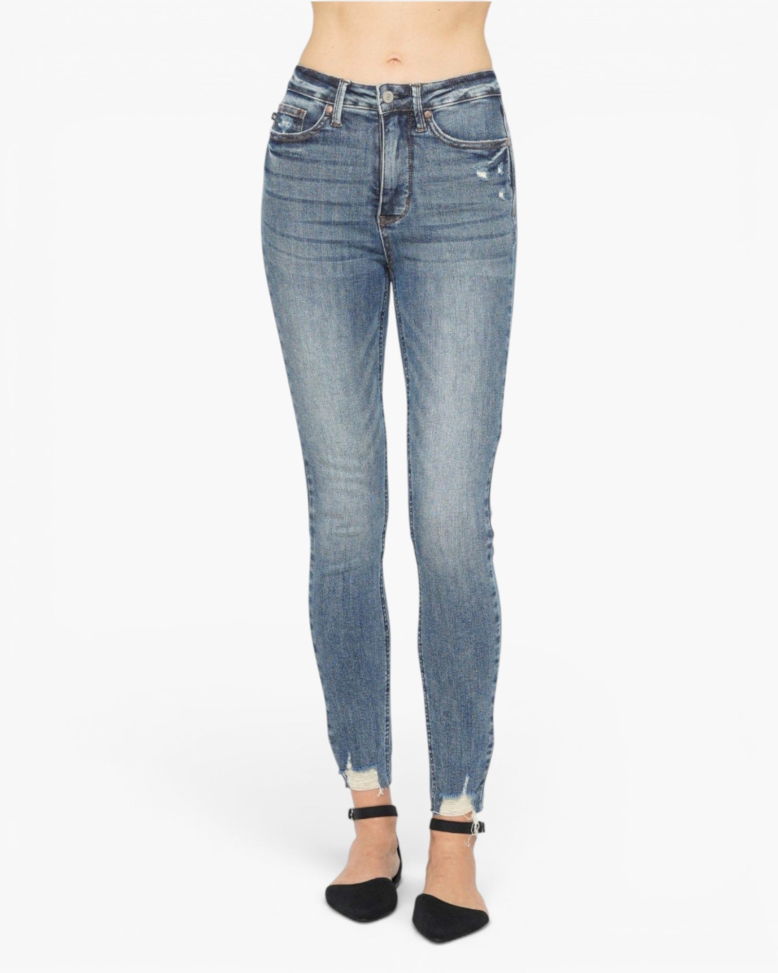 A person wearing light-wash blue skinny jeans with a distressed, faded look and rolled cuffs, paired with black ankle-strap heels, shown against a plain white studio background.