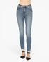 A person wearing light-wash blue skinny jeans with a distressed, faded look and rolled cuffs, paired with black ankle-strap heels, shown against a plain white studio background.