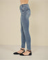 Person wearing light blue jeans on a plain background