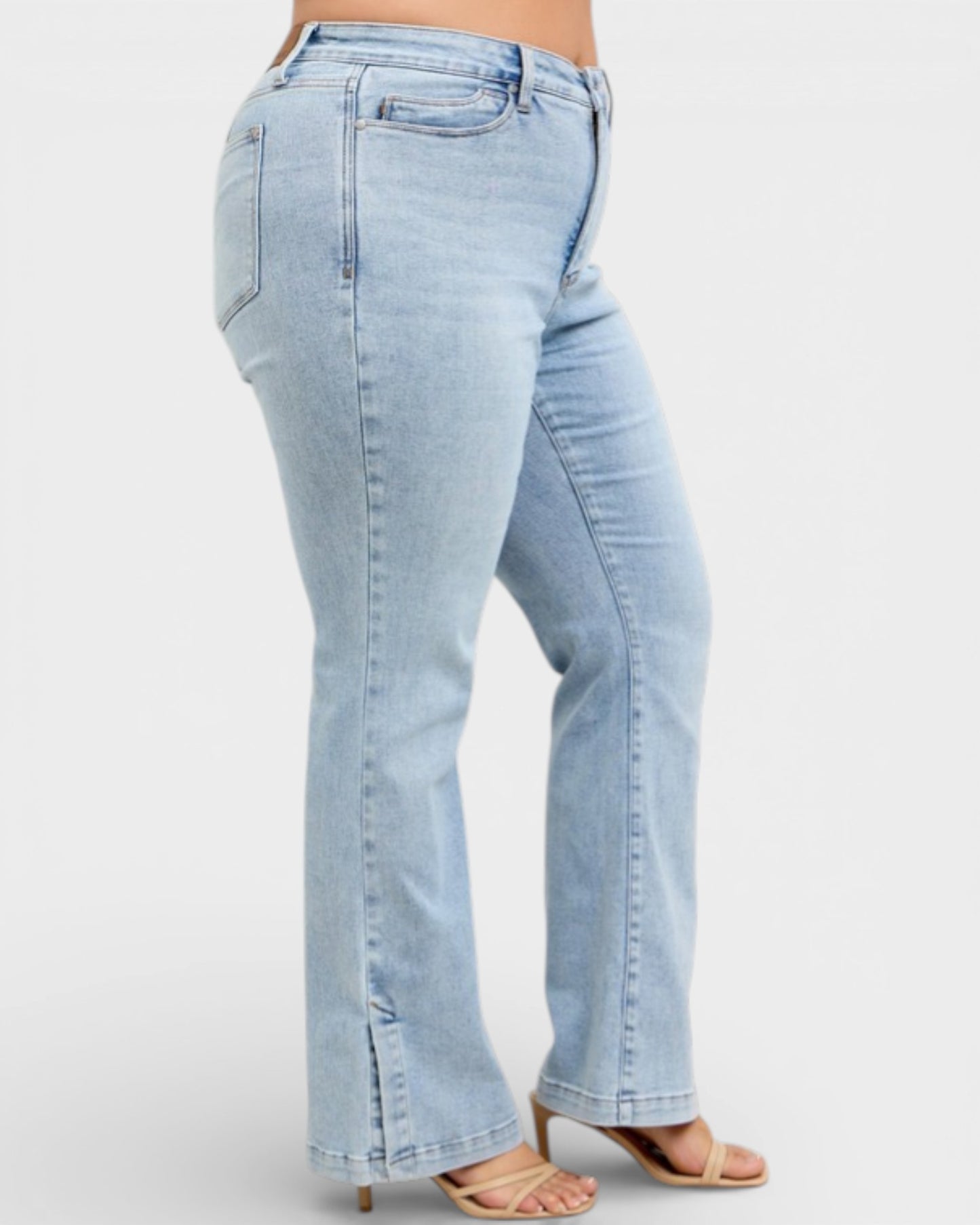 Light blue jeans worn by a person on a white background
