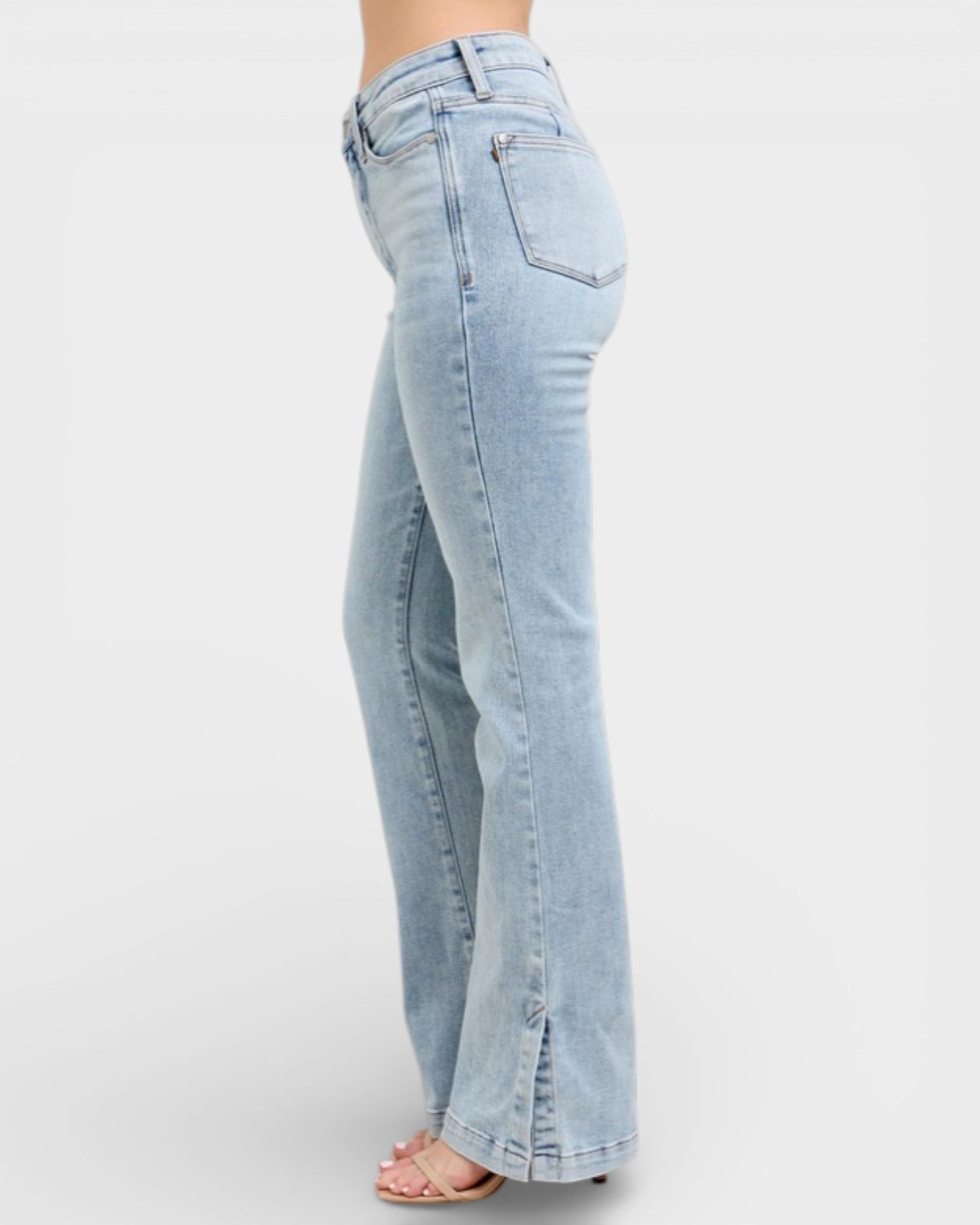 Light blue jeans worn by a person on a white background