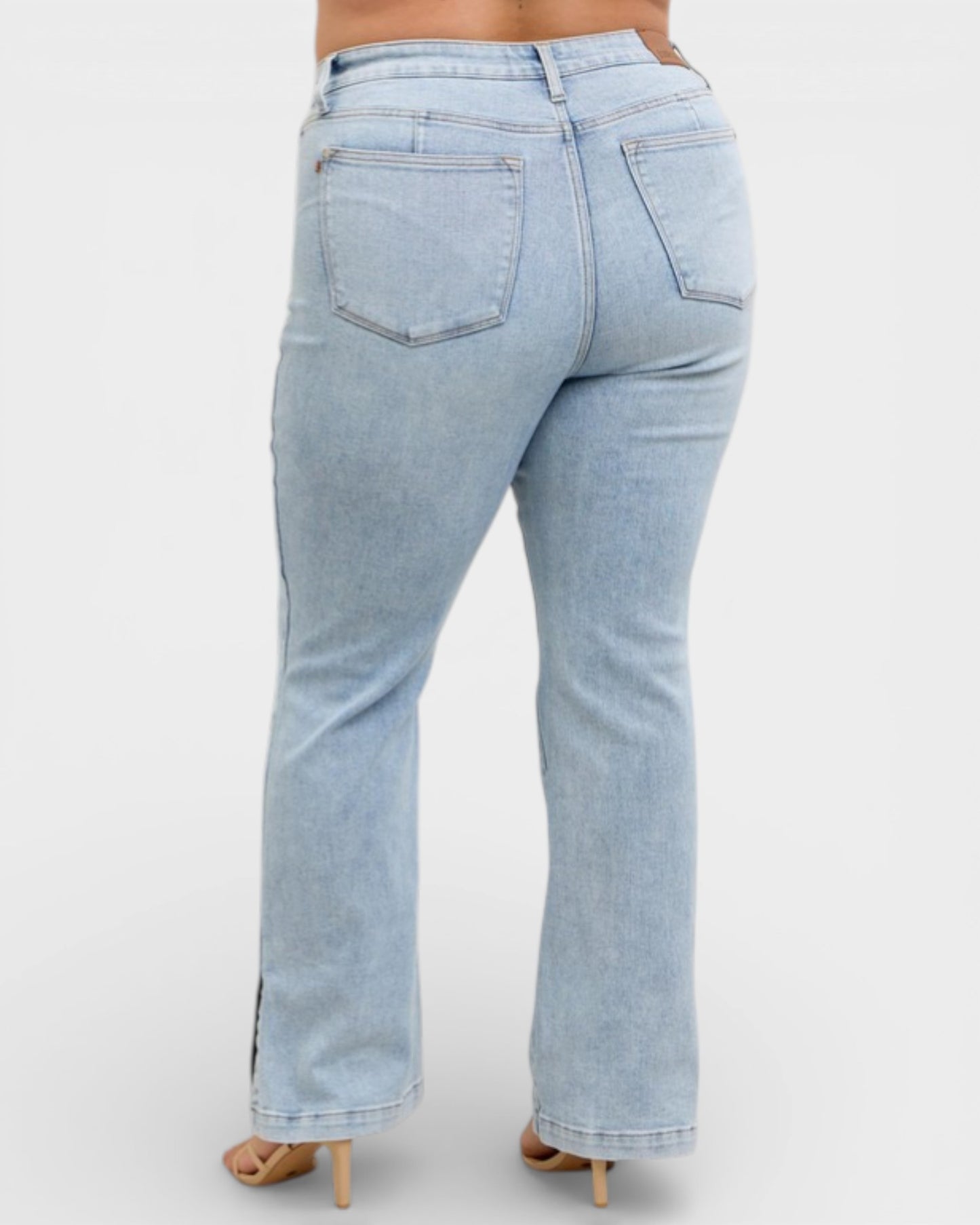 Light blue jeans worn by a person on a white background