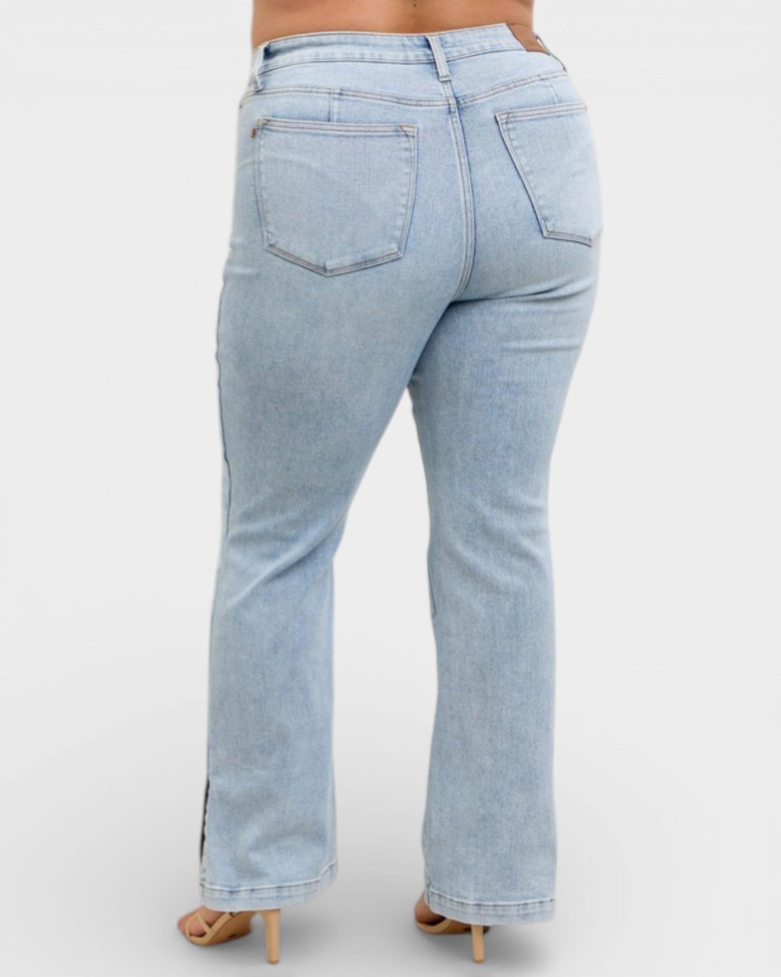 Light blue jeans worn by a person on a white background