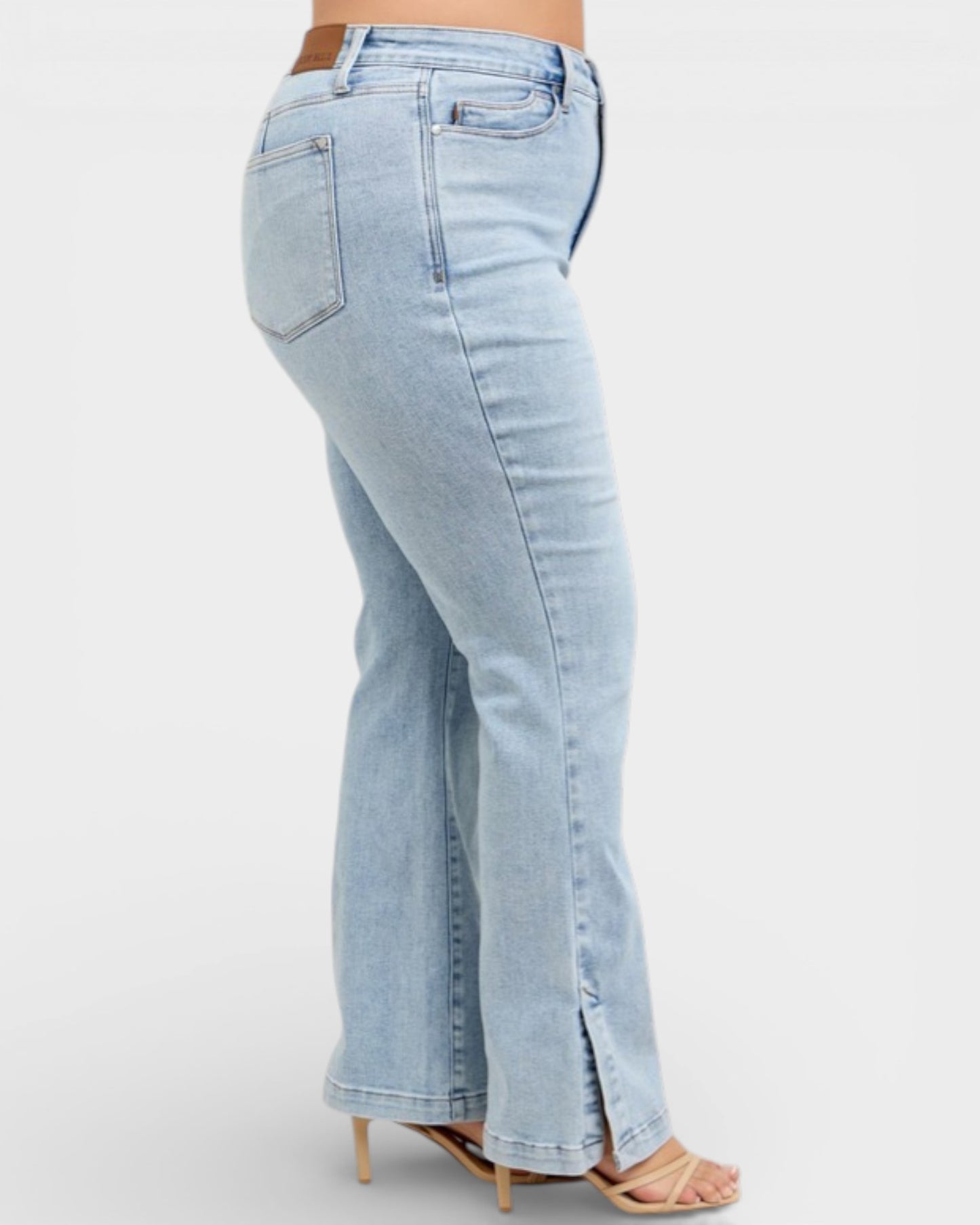 Light blue jeans worn by a person on a white background