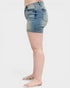 Denim shorts worn by a person on a white background
