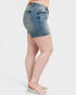 Denim shorts worn by a person on a white background