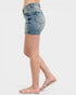 Denim shorts worn by a person on a white background