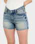 Blue denim shorts worn by a person on a white background