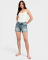 Woman wearing a white top and denim shorts on a white background