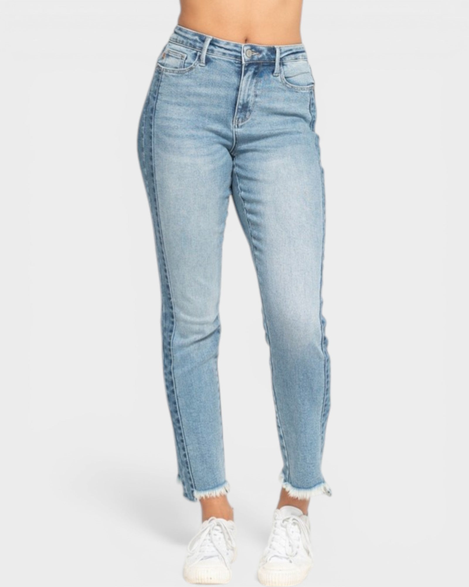 Light blue jeans worn by a person on a white background