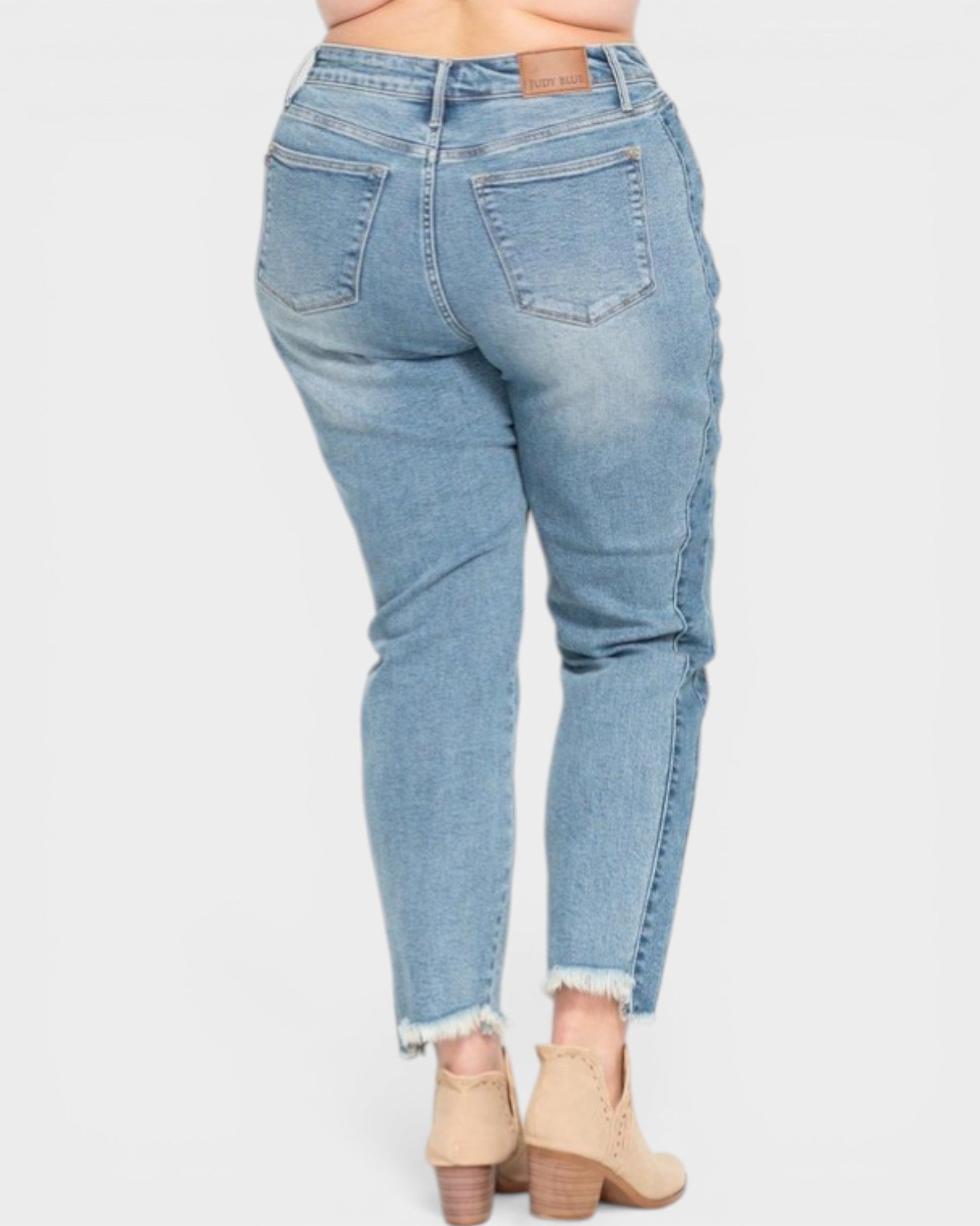 Light blue jeans worn by a person on a white background