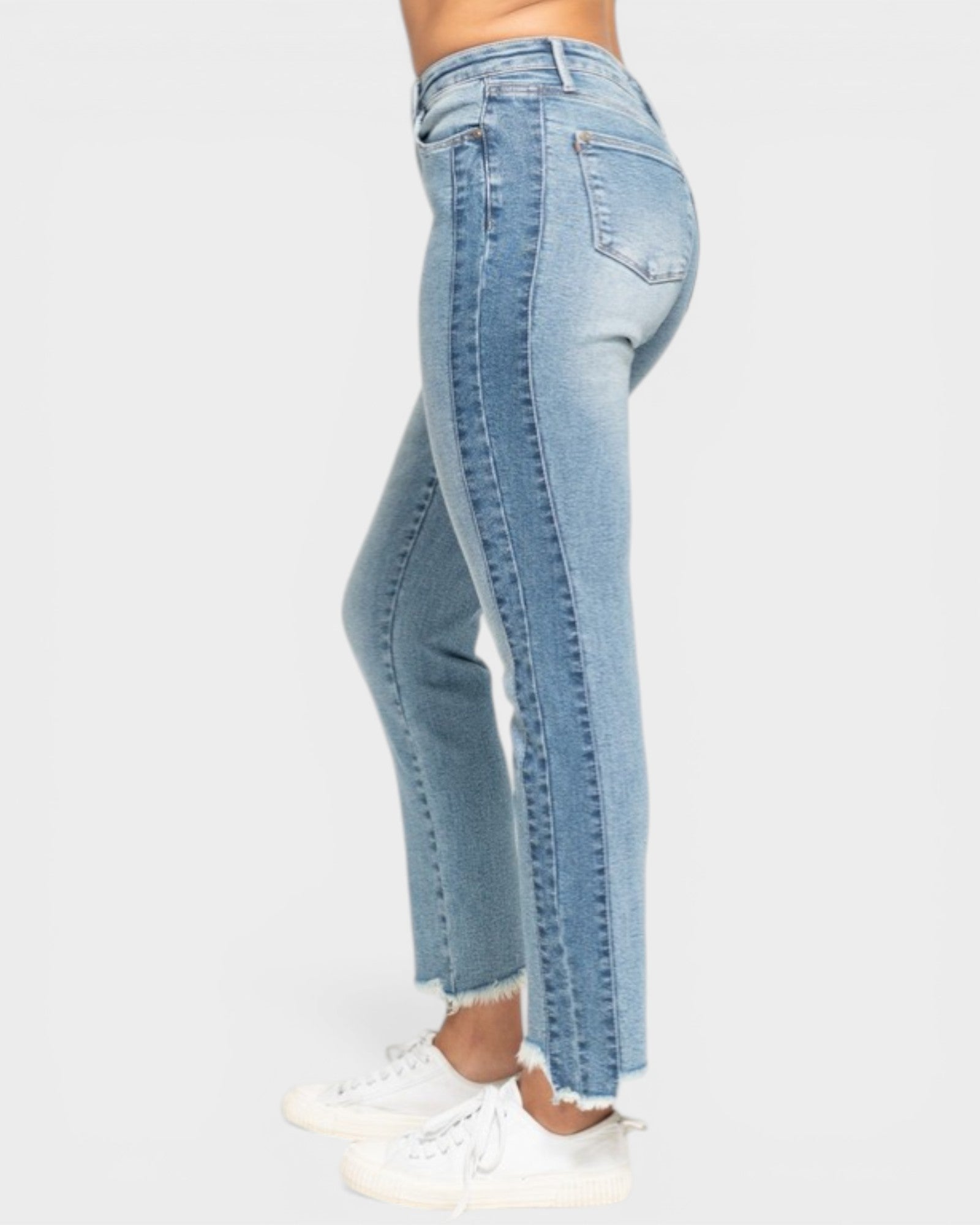 Light blue jeans worn by a person on a white background