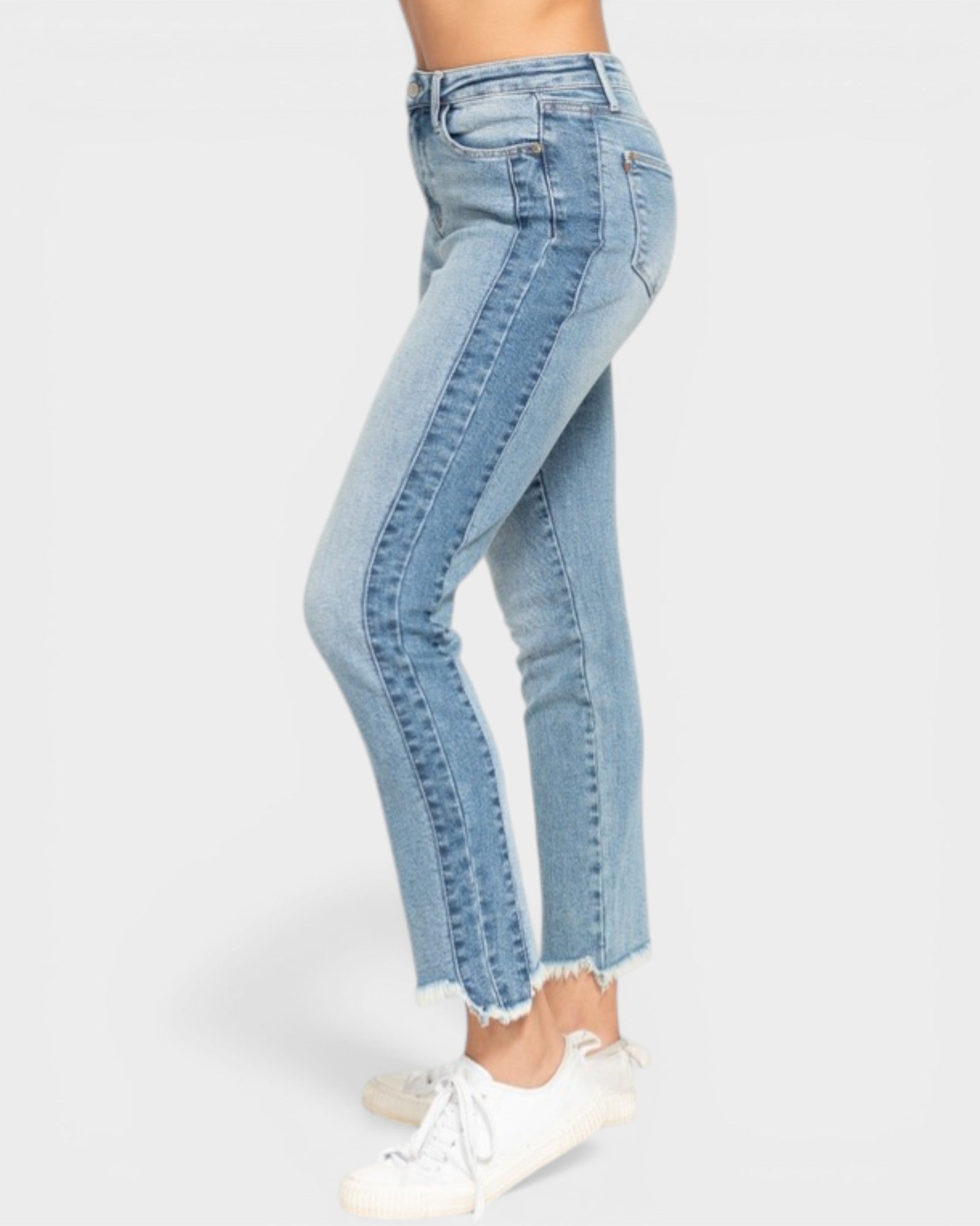 Light blue jeans worn by a person on a white background