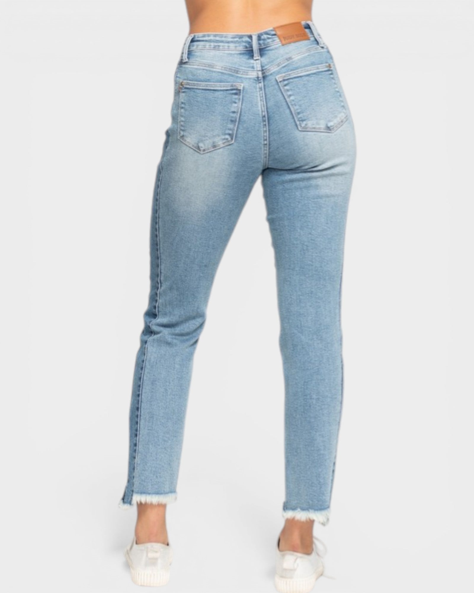 Light blue jeans worn by a person on a white background