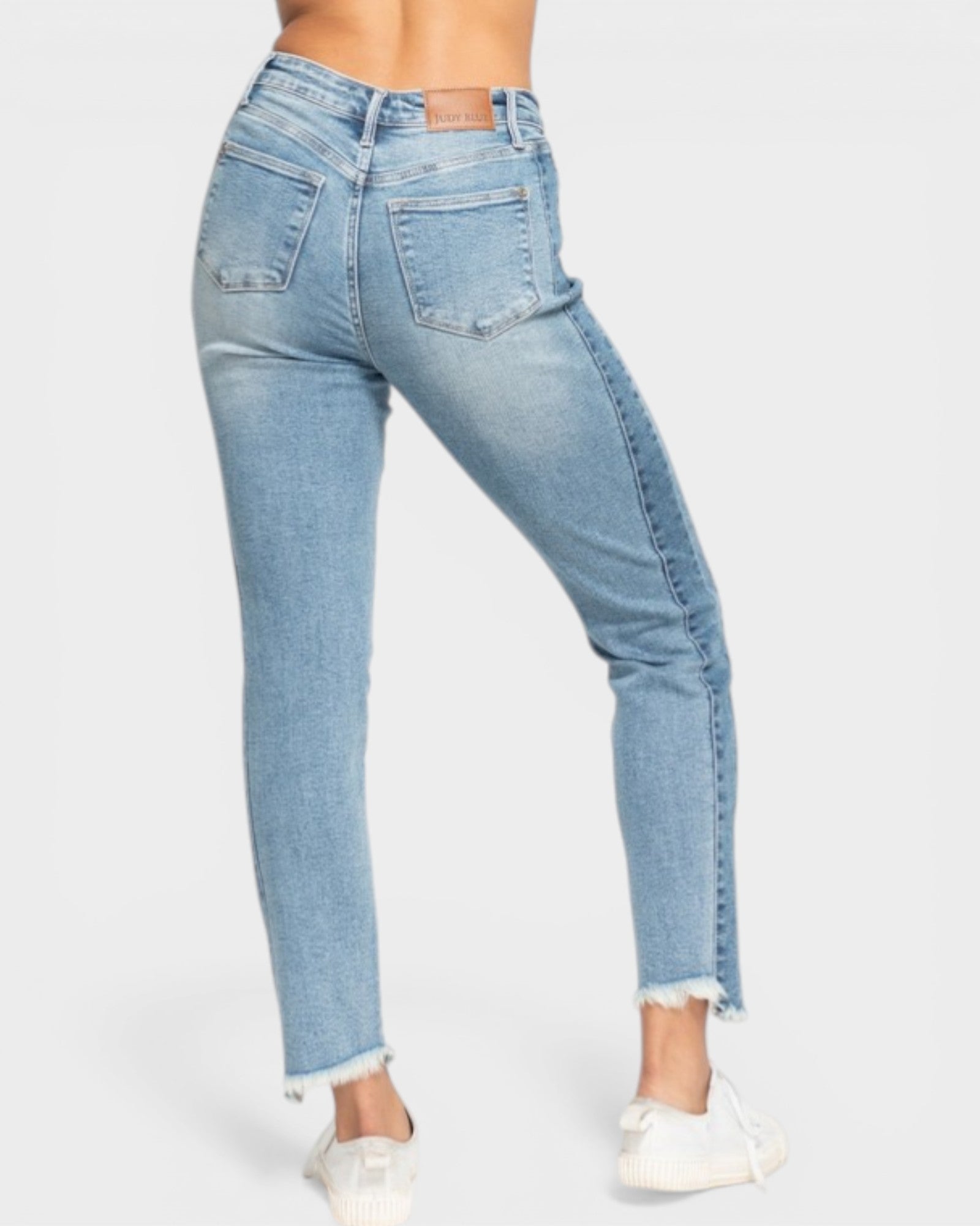 Light blue jeans worn by a person on a white background